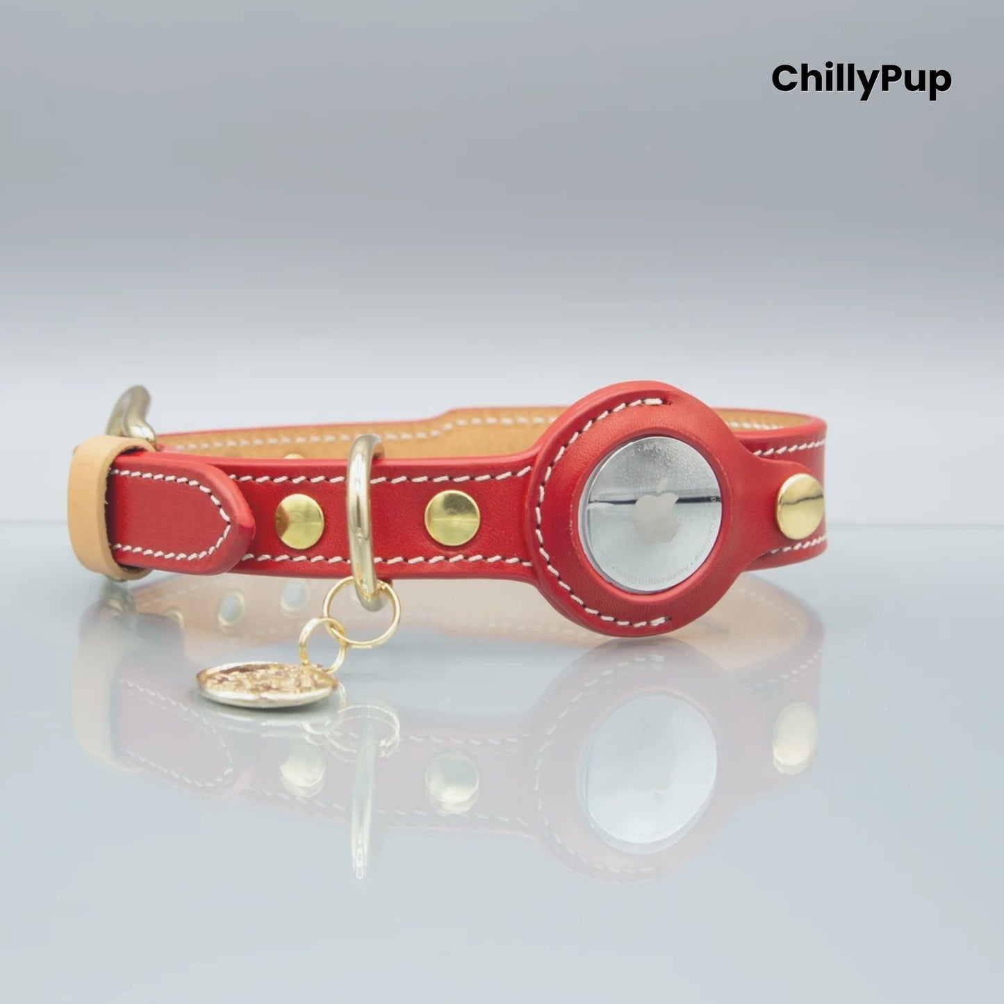 Red leather dog collar with gold accents and a tag on a light grey background, branded 'ChillyPup'.