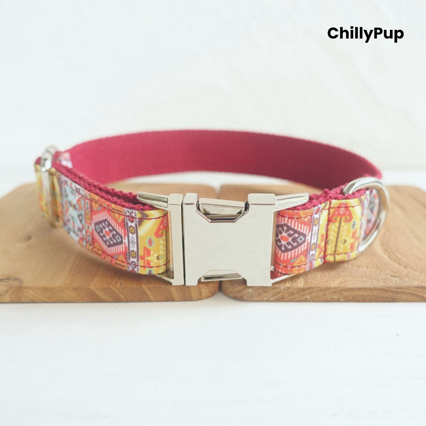 Dog collar with colourful pattern and metallic clasp on a white background, branded 'ChillyPup'.