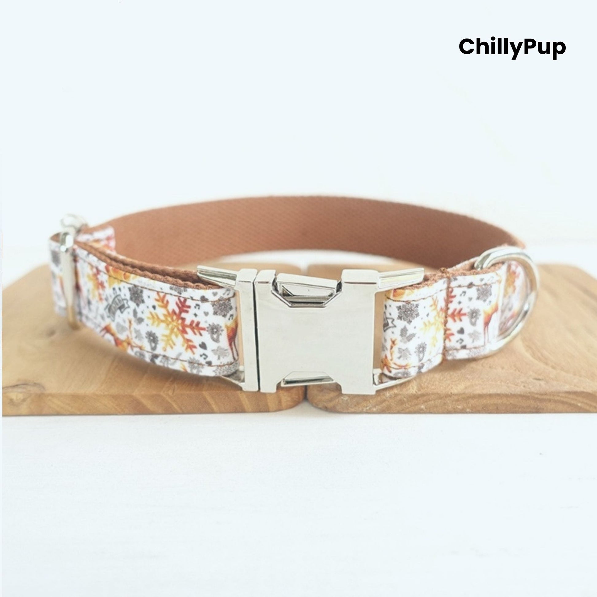 Dog collar with Christmas pattern and silver hardware on a white background, branded 'ChillyPup'.