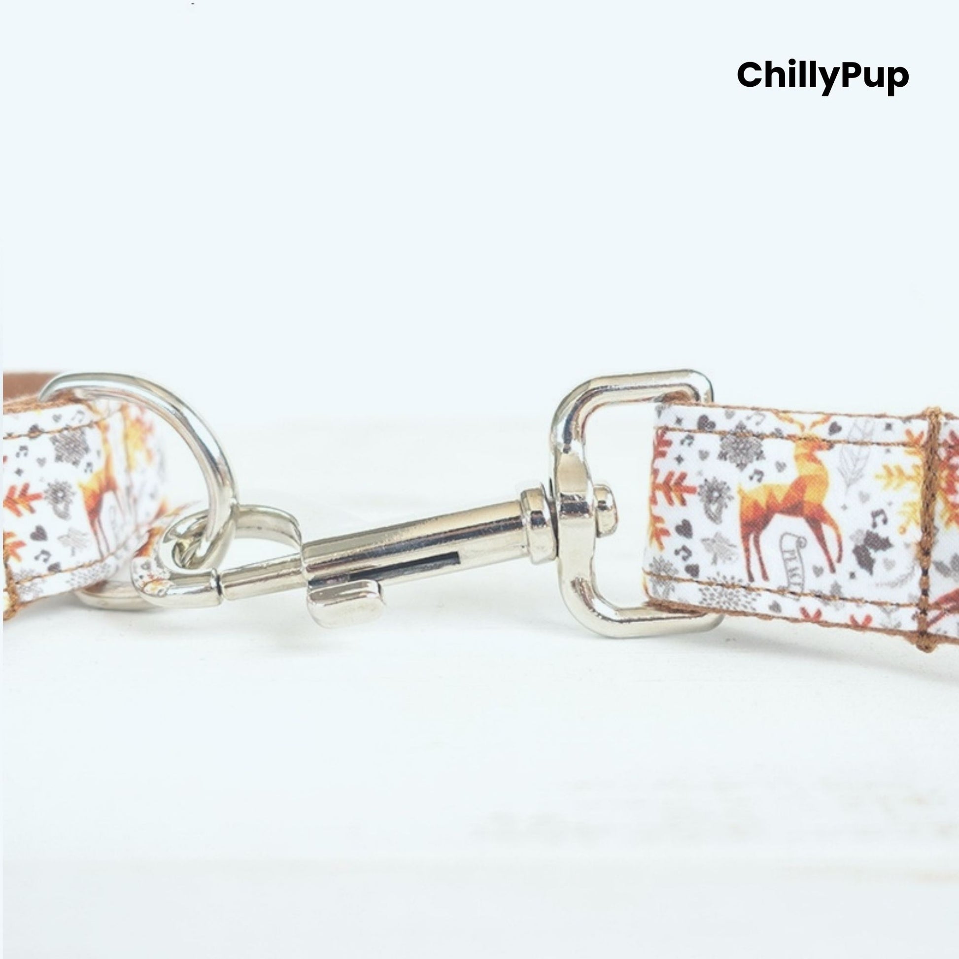 Dog collar with Christmas pattern and silver hardware on a white background, branded 'ChillyPup'.