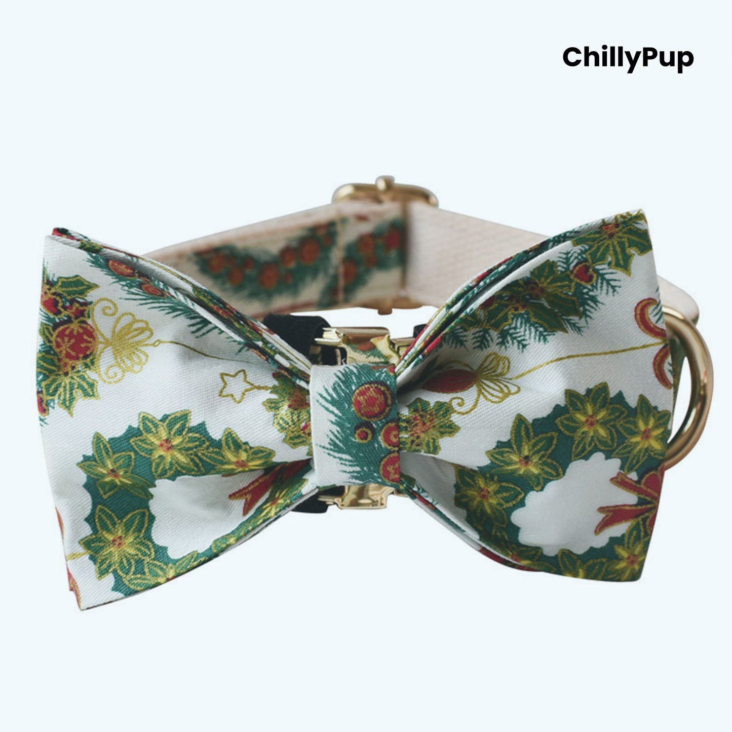 Dog collar with a festive bow tie featuring Christmas-themed patterns on a white background.