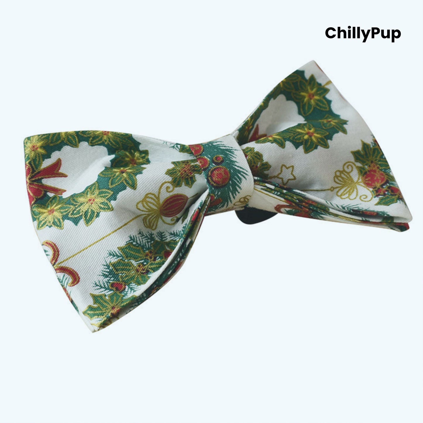 Christmas-themed dog bow tie with wreaths and berries on a white background, branded 'ChillyPup'