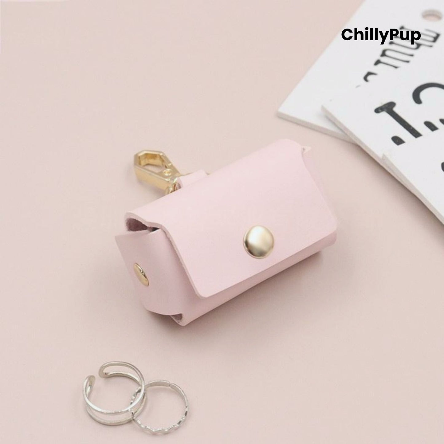 pink leather ring pouch with gold accents on a light pink background, featuring the brand 'ChillyPup'.