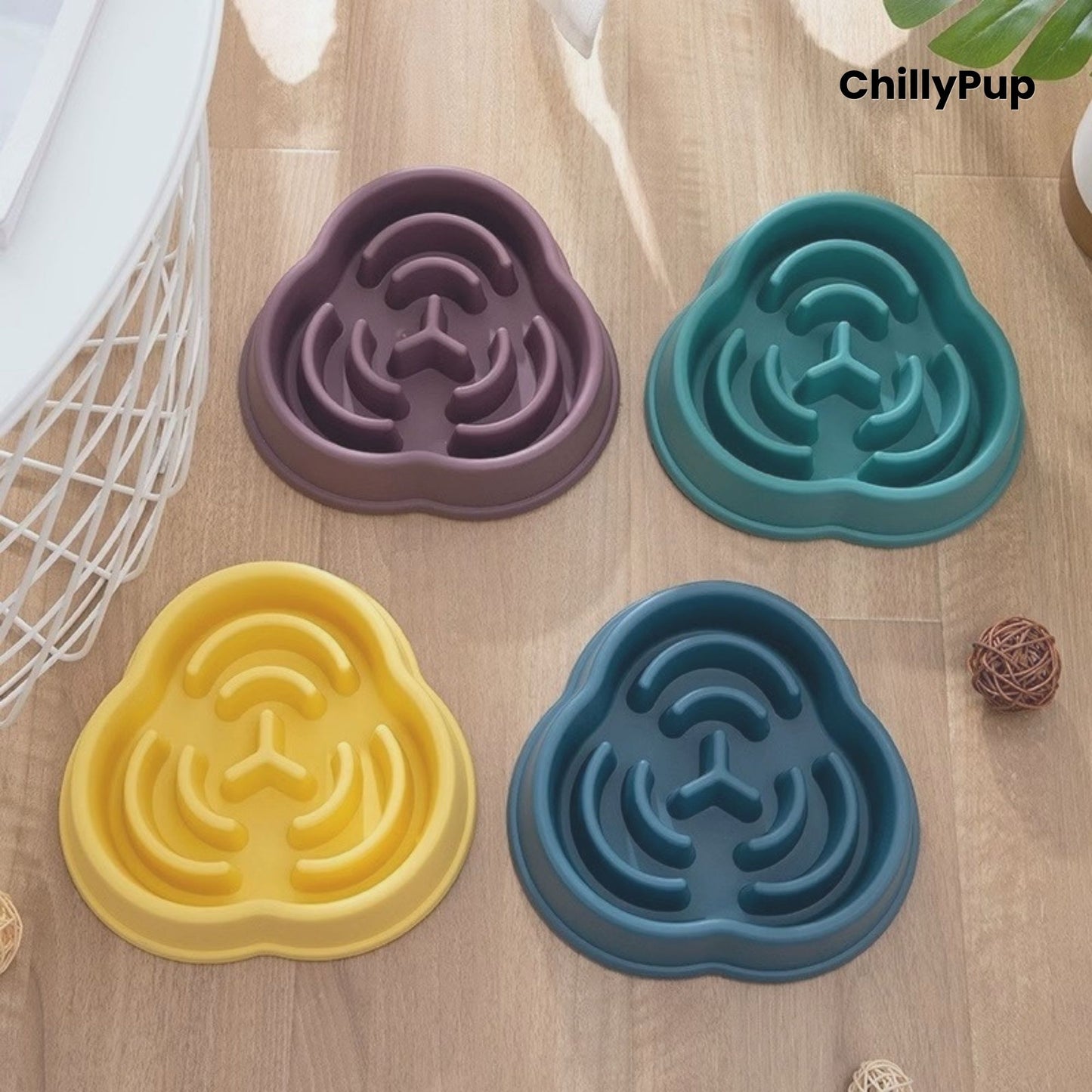 Four pet bowls with maze design on a wooden surface, branded 'ChillyPup'.
