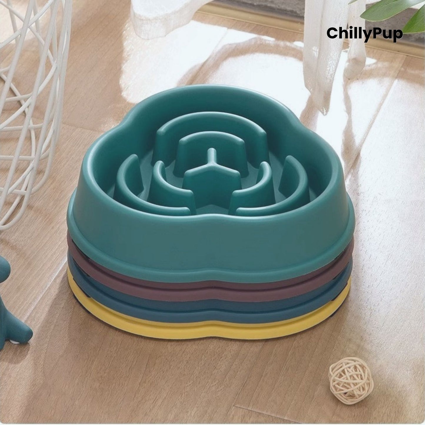 Four pet bowls with maze design on a wooden surface, branded 'ChillyPup'.