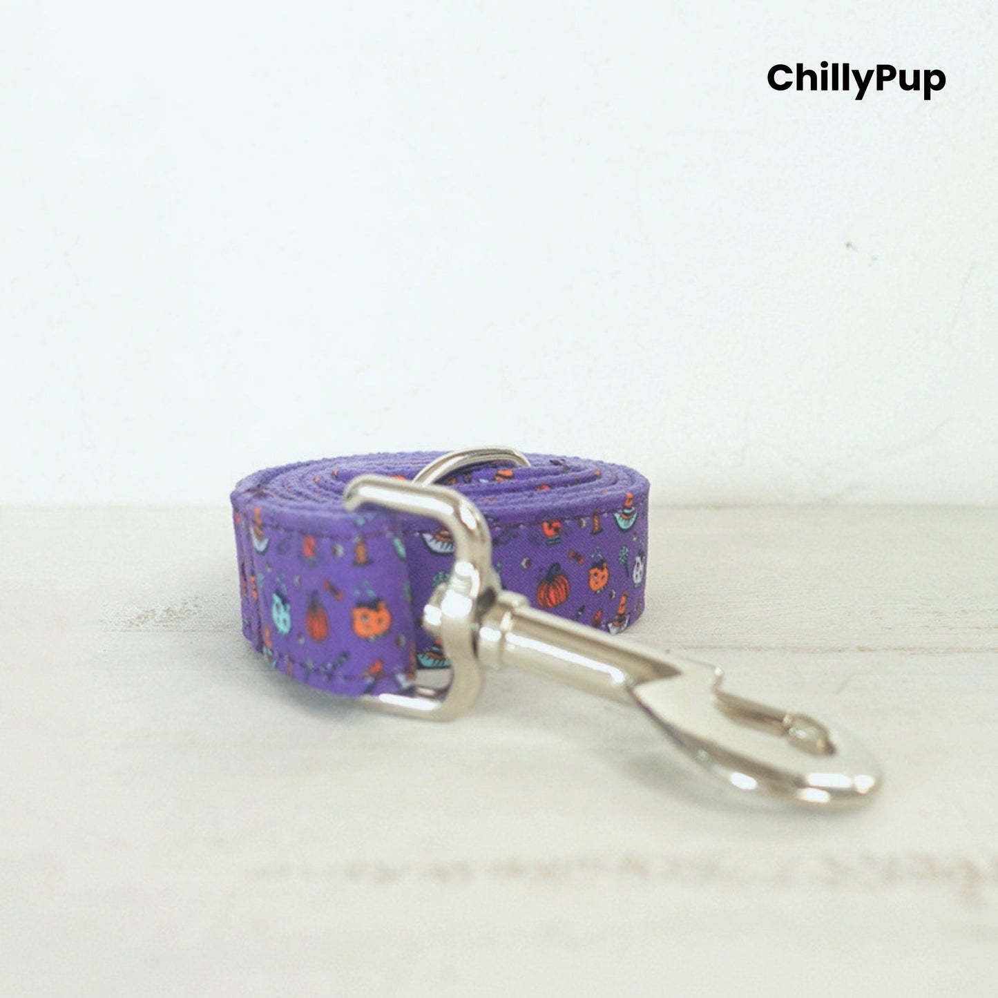 Purple Halloween dog collar on a wooden board, branded 'ChillyPup