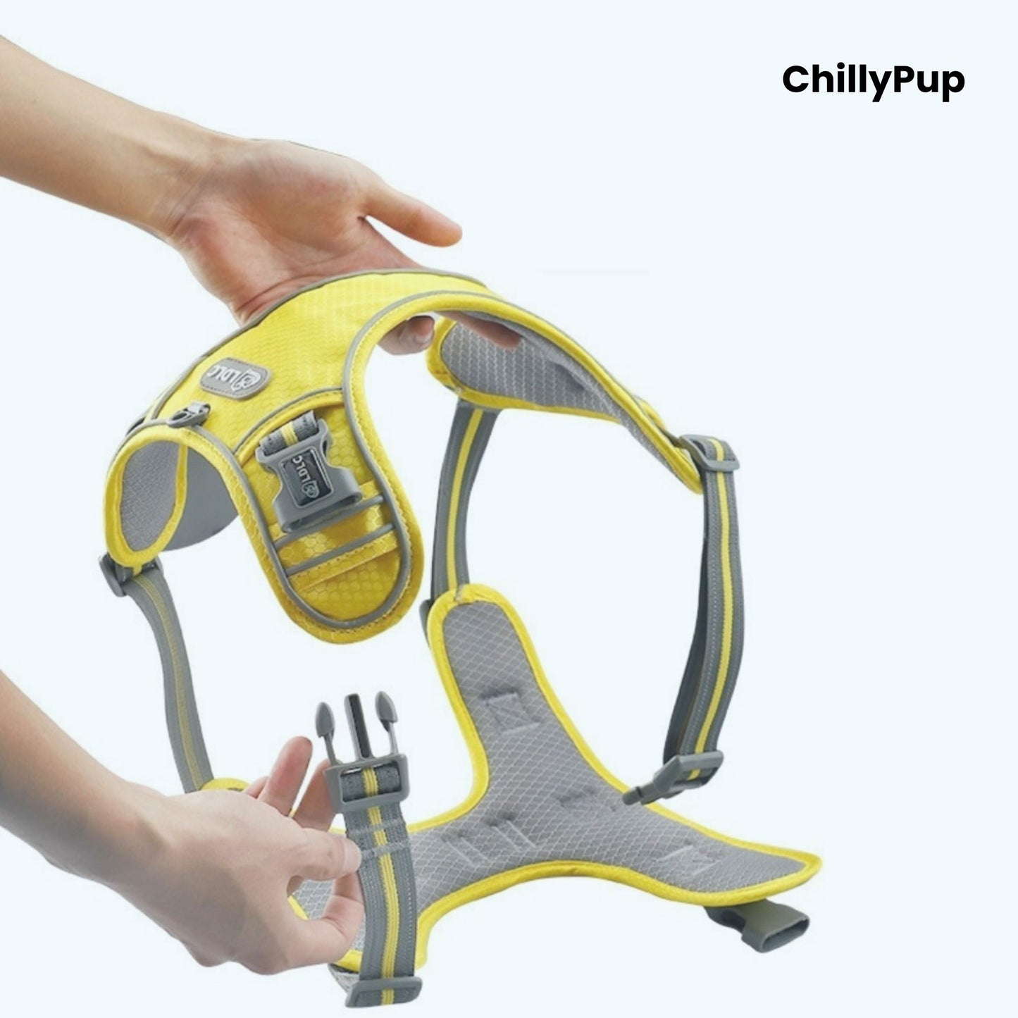 Yellow and grey dog harness being held by a person with 'ChillyPup' branding.