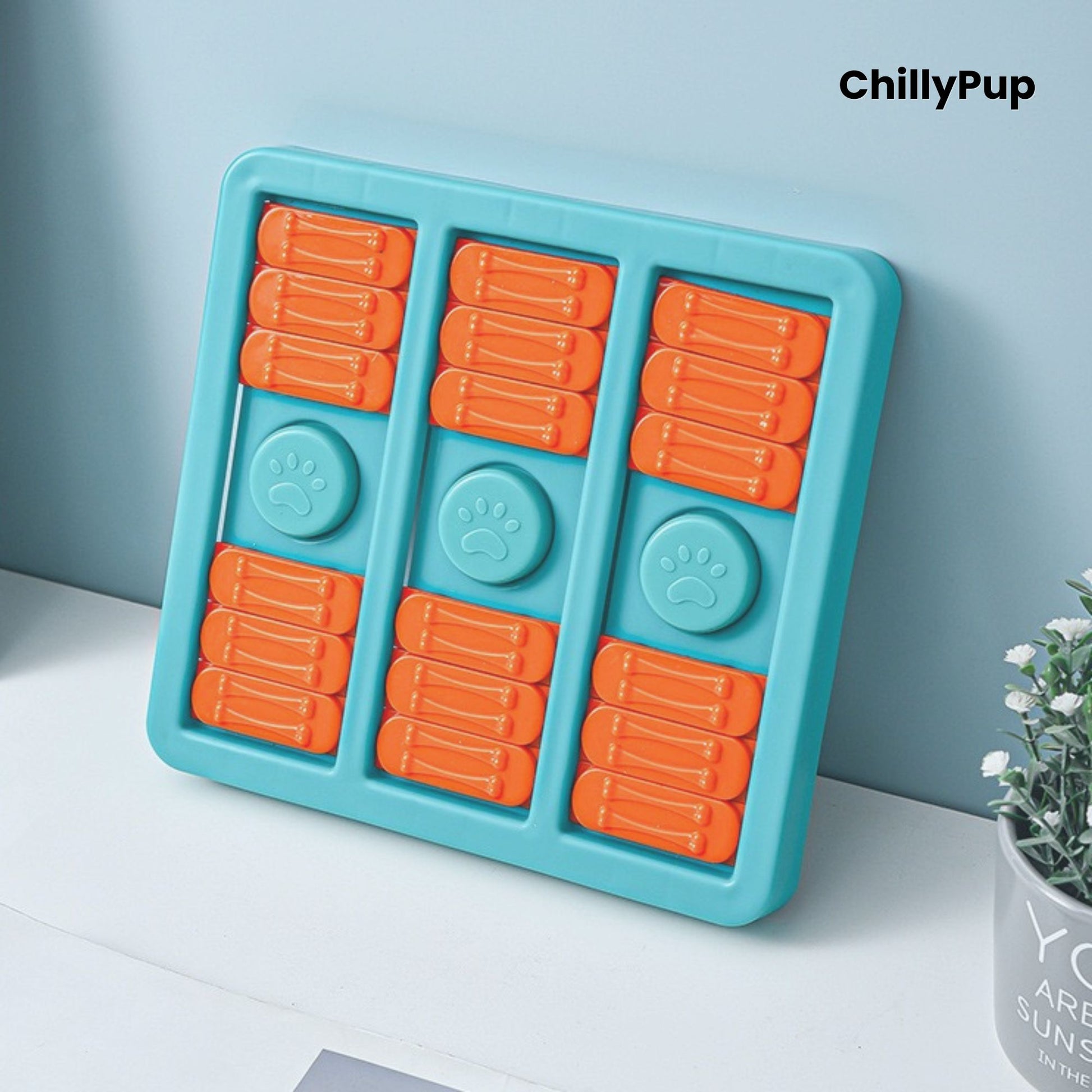 Blue plastic pet toy with orange and green shapes on a white surface, branded 'ChillyPup'.