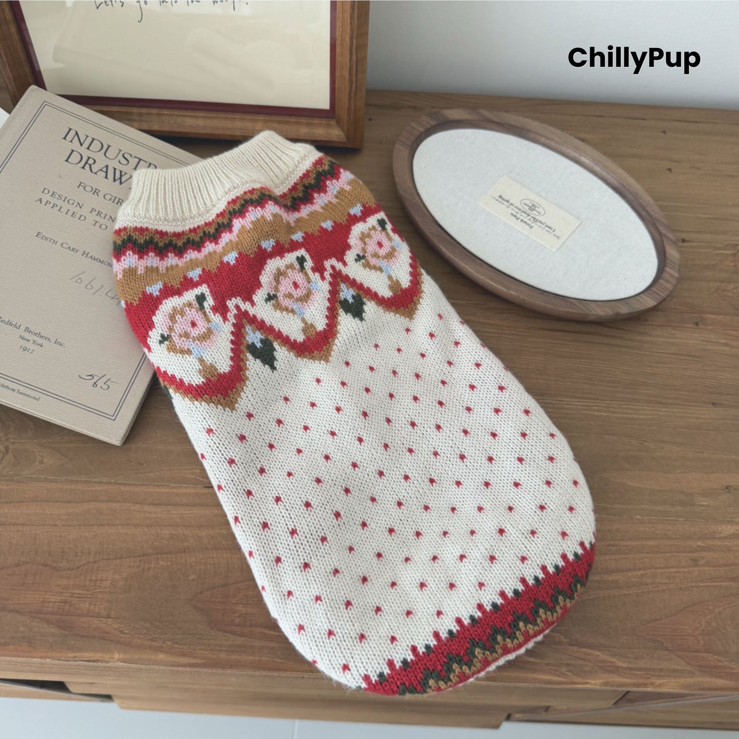Knitted dog jumper, white on a wooden surface with 'ChillyPup' branding.