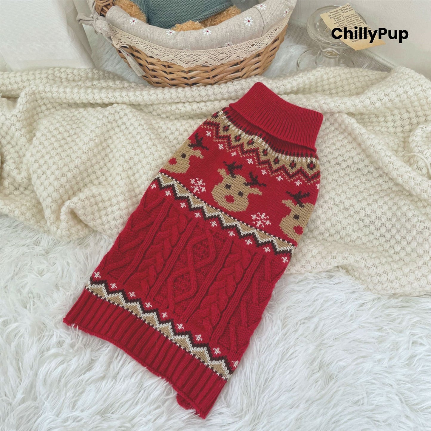 Red knitted dog sweater with Christmas pattern on a white blanket, branded 'ChillyPup'.