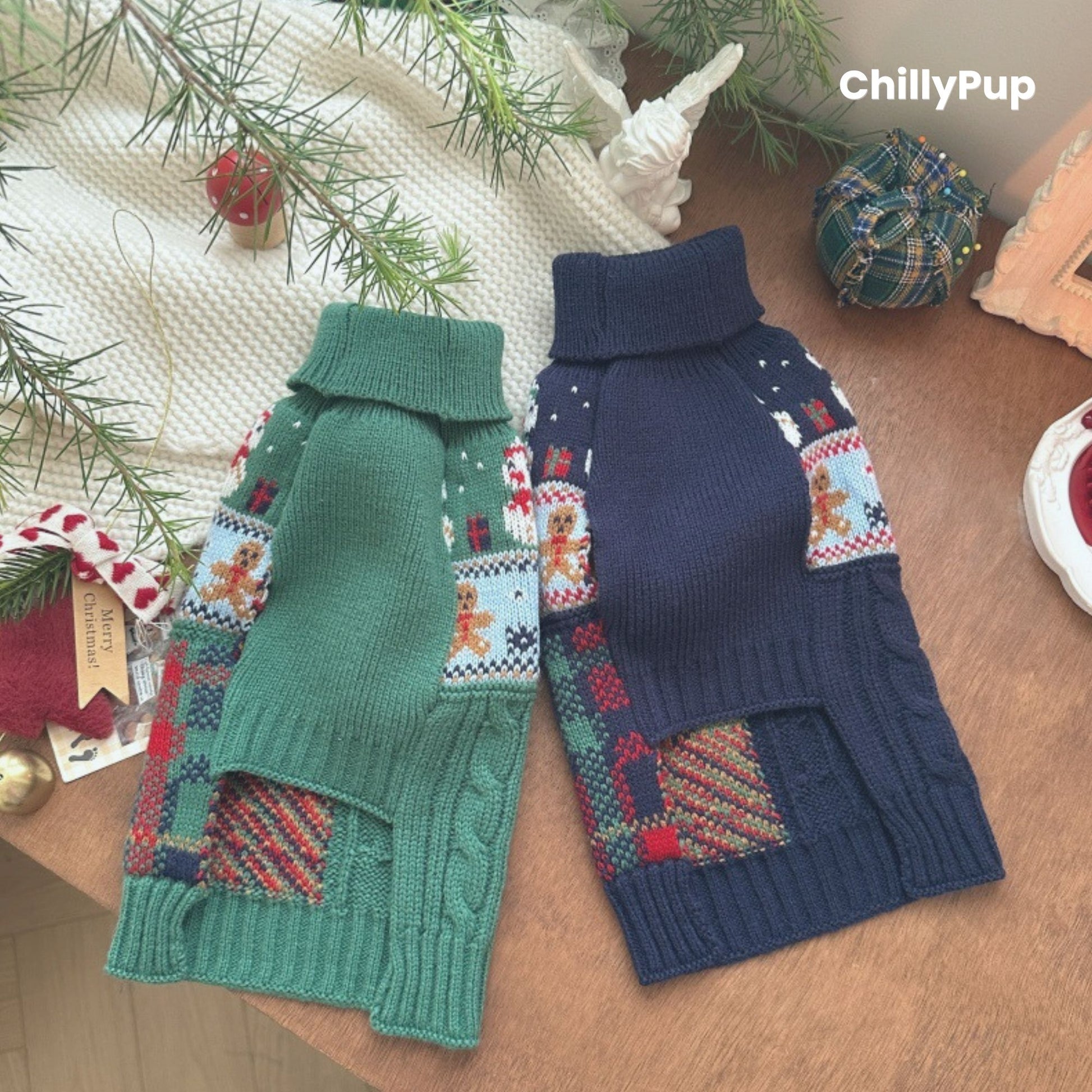 Knitted dog sweater with Christmas design on a wooden surface, surrounded by festive decor. branded with ChillyPup.
