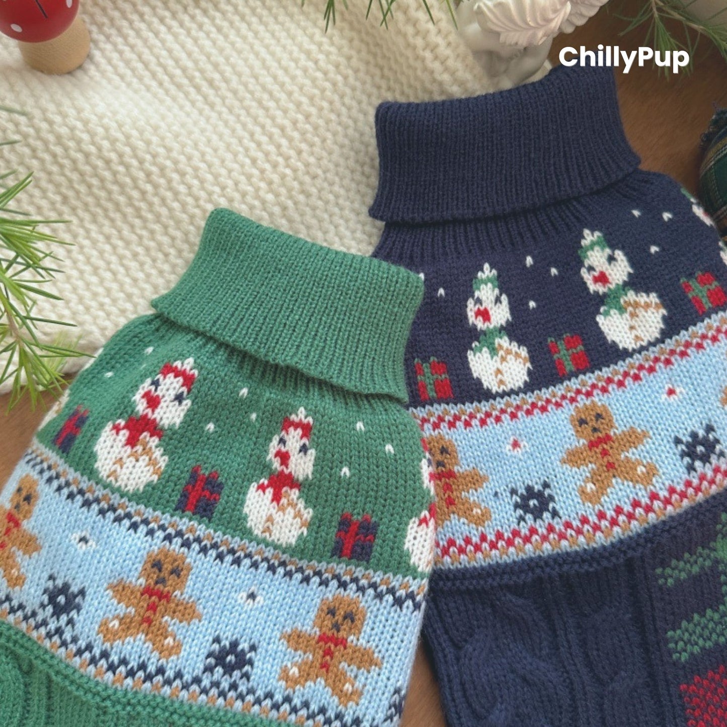 Knitted dog sweater with Christmas design on a wooden surface, surrounded by festive decor. branded with ChillyPup.