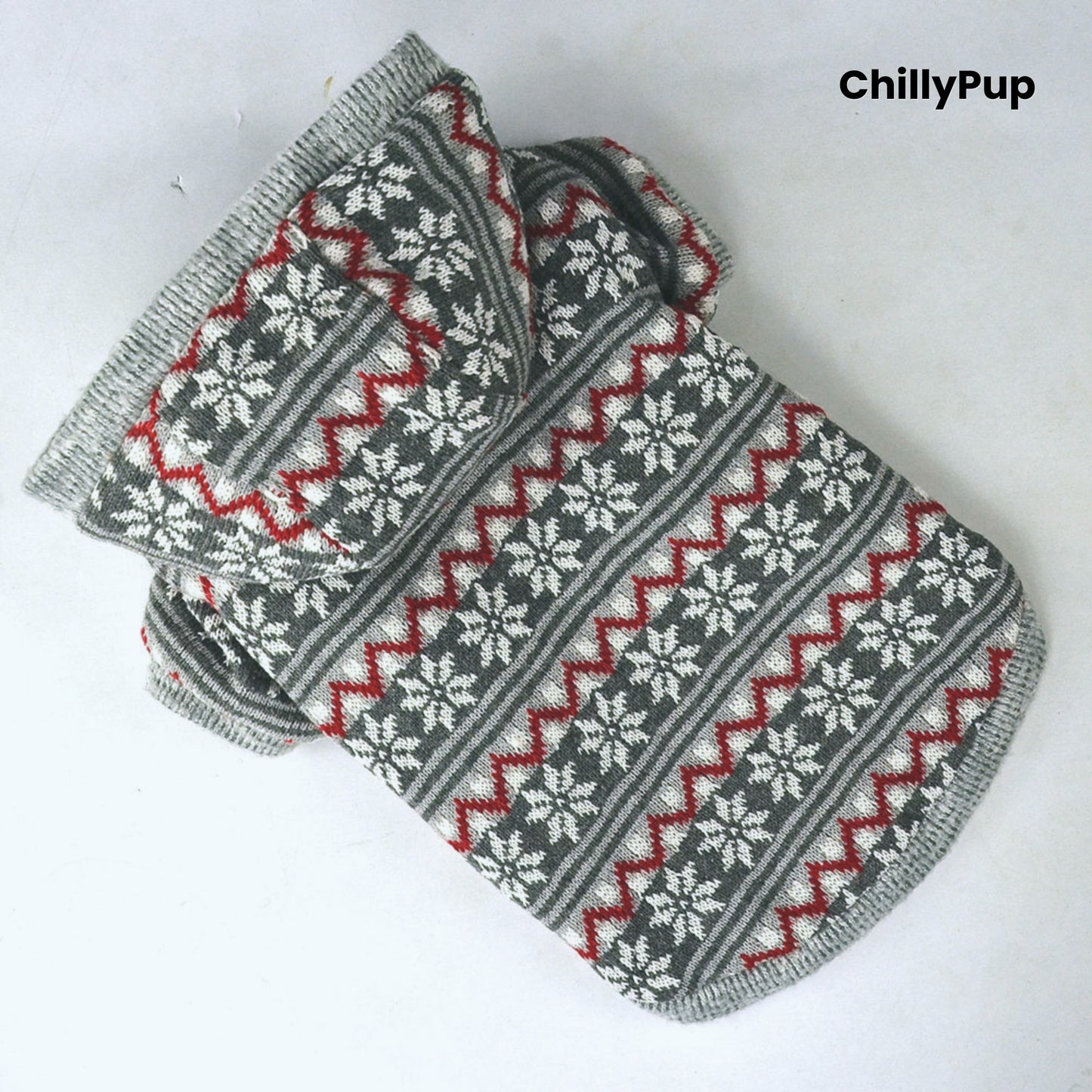 Grey and patterned dog Christmas jumper with white lining on a light grey background, branded 'ChillyPup'.