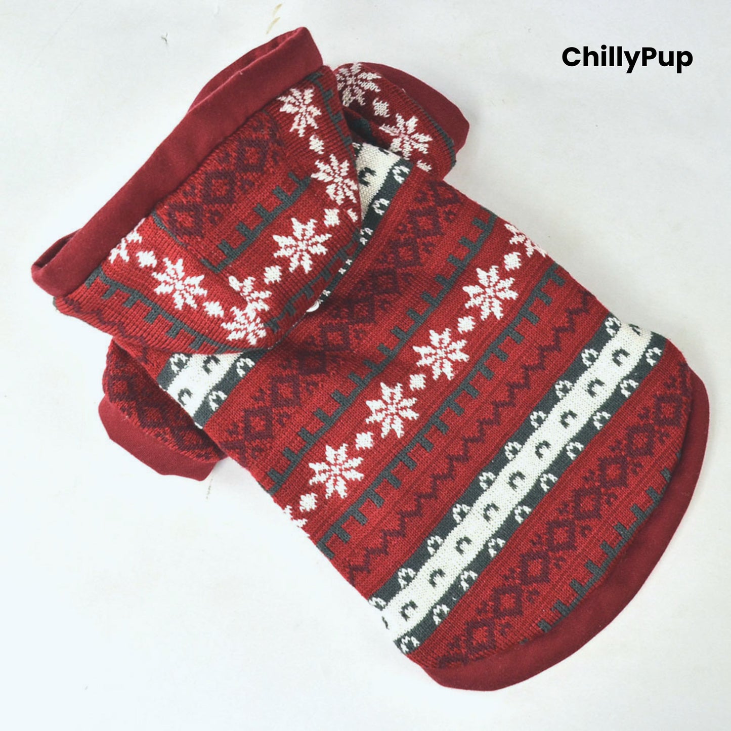 Red and patterned dog Christmas jumper with white lining on a light grey background, branded 'ChillyPup'.