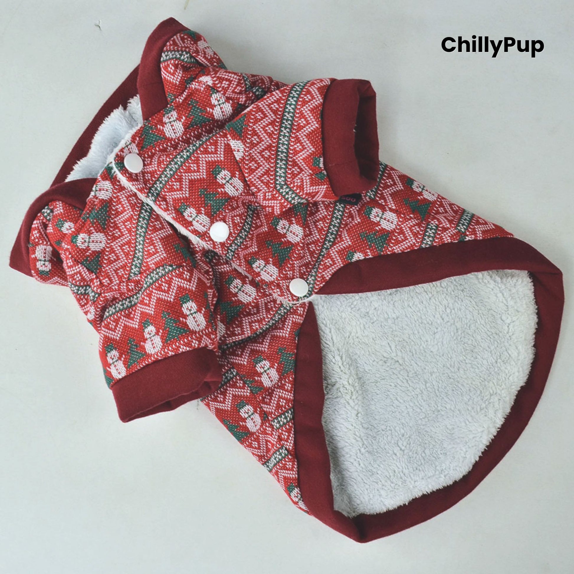 Red and patterned dog Christmas jumper with white lining on a light grey background, branded 'ChillyPup'.