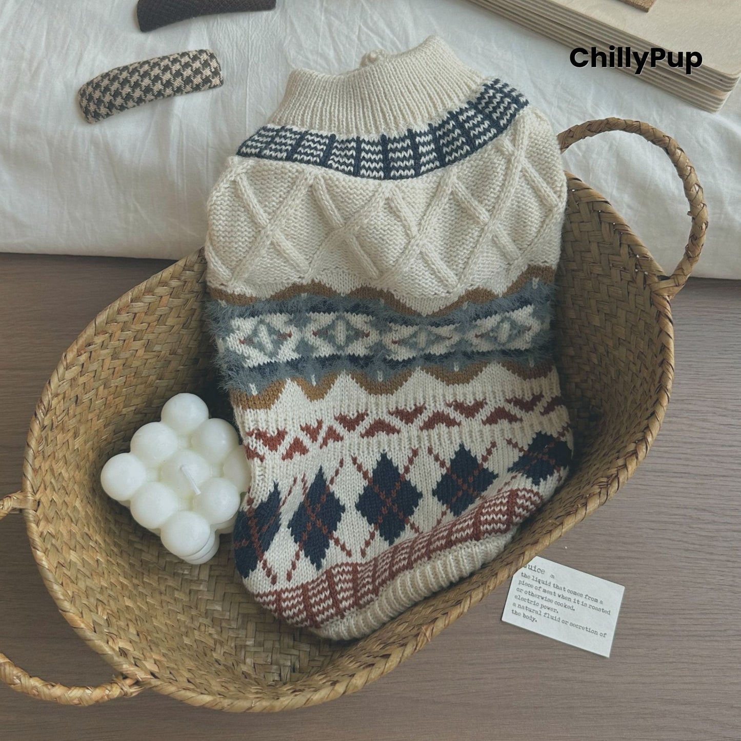 Knitted dog sweater with geometric pattern on a wooden surface, brand 'ChillyPup' visible.