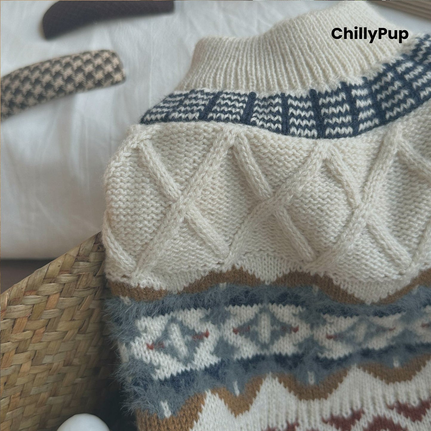 Knitted dog sweater with geometric pattern on a wooden surface, brand 'ChillyPup' visible.