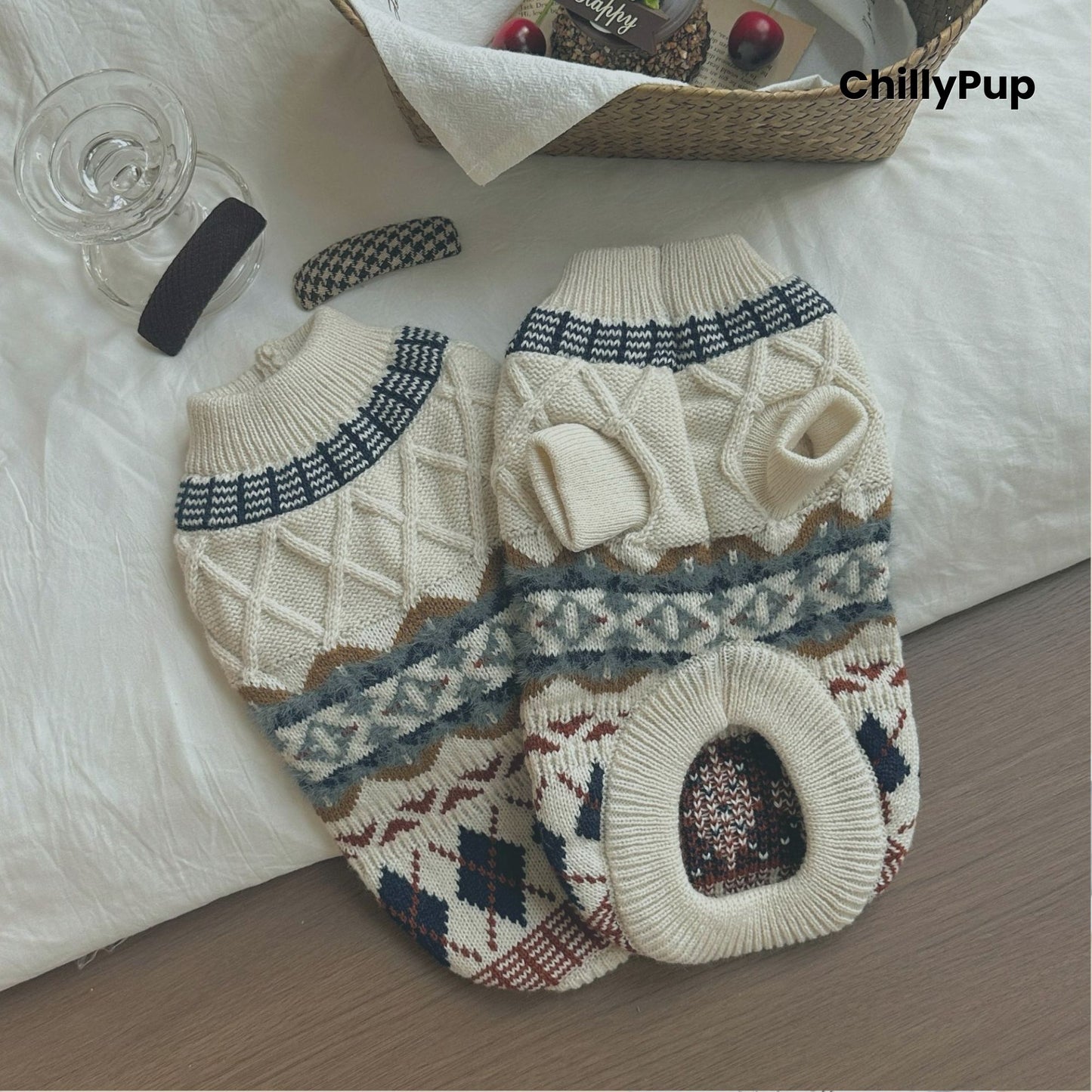 Two knitted dog sweaters with a geometric pattern on a white surface, branded 'ChillyPup'.