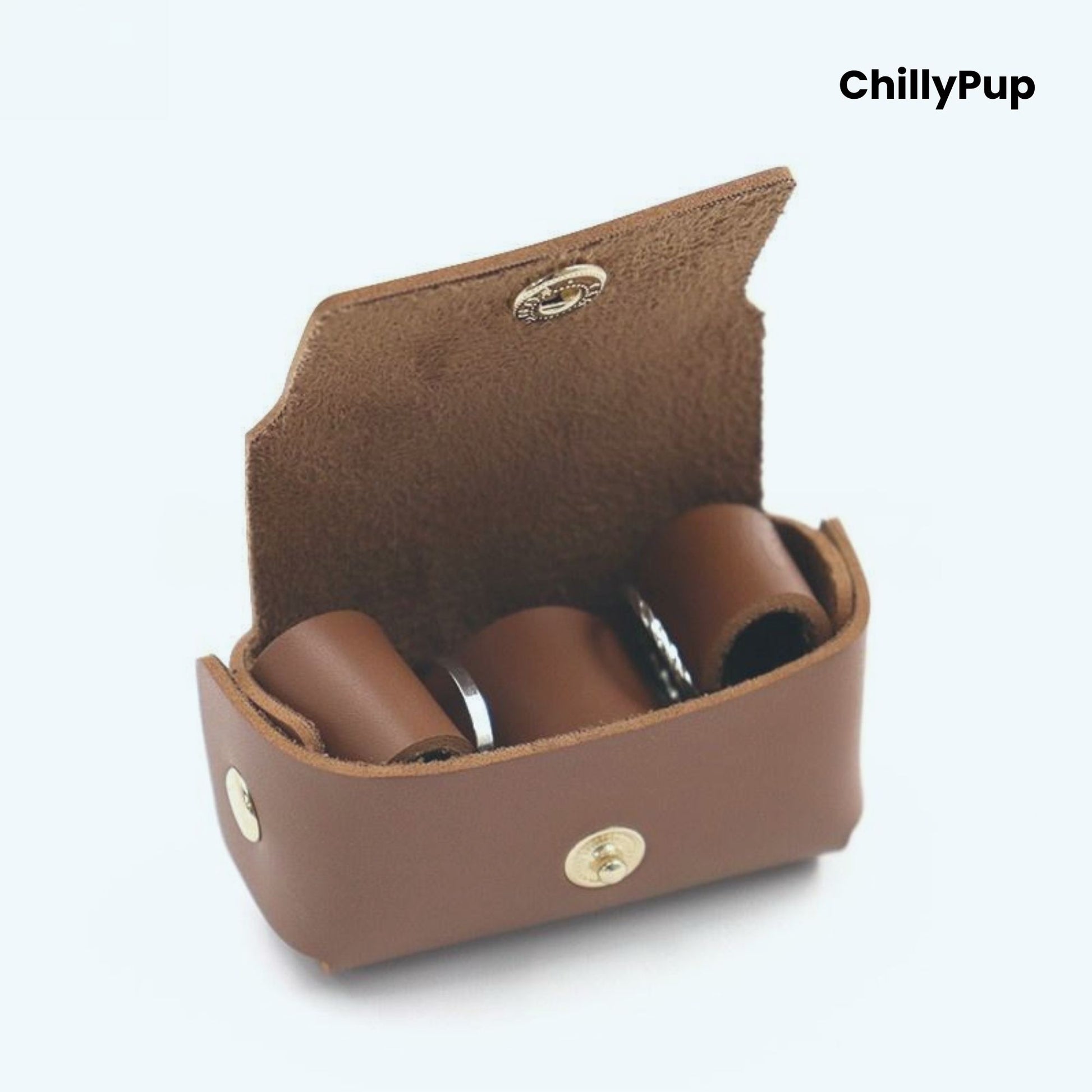 Brown leather ring case with three cylindrical items inside, branded 'ChillyPup'.