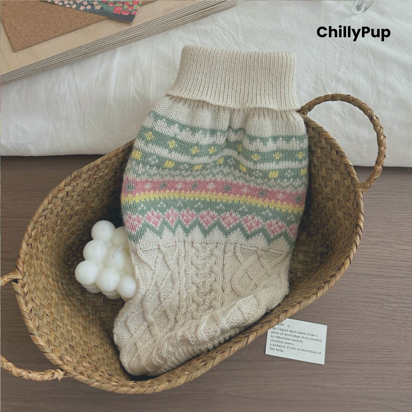 Knitted dog sweater with floral patterns on a wooden surface, branded 'ChillyPup'.
