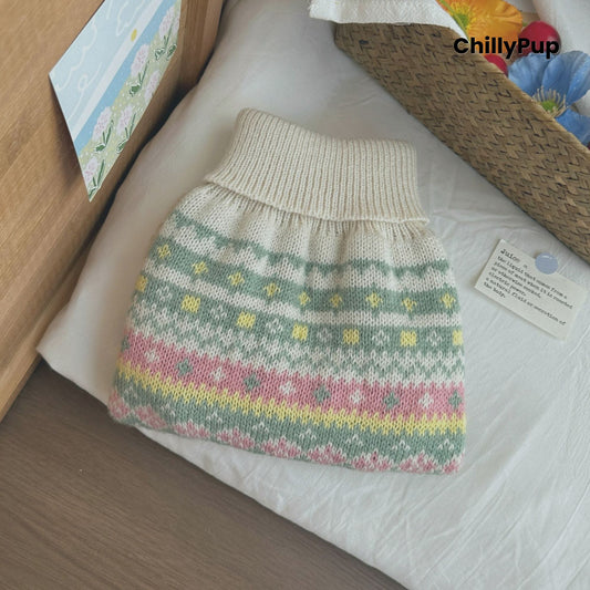 Knitted dog sweater with floral patterns on a wooden surface, branded 'ChillyPup'.