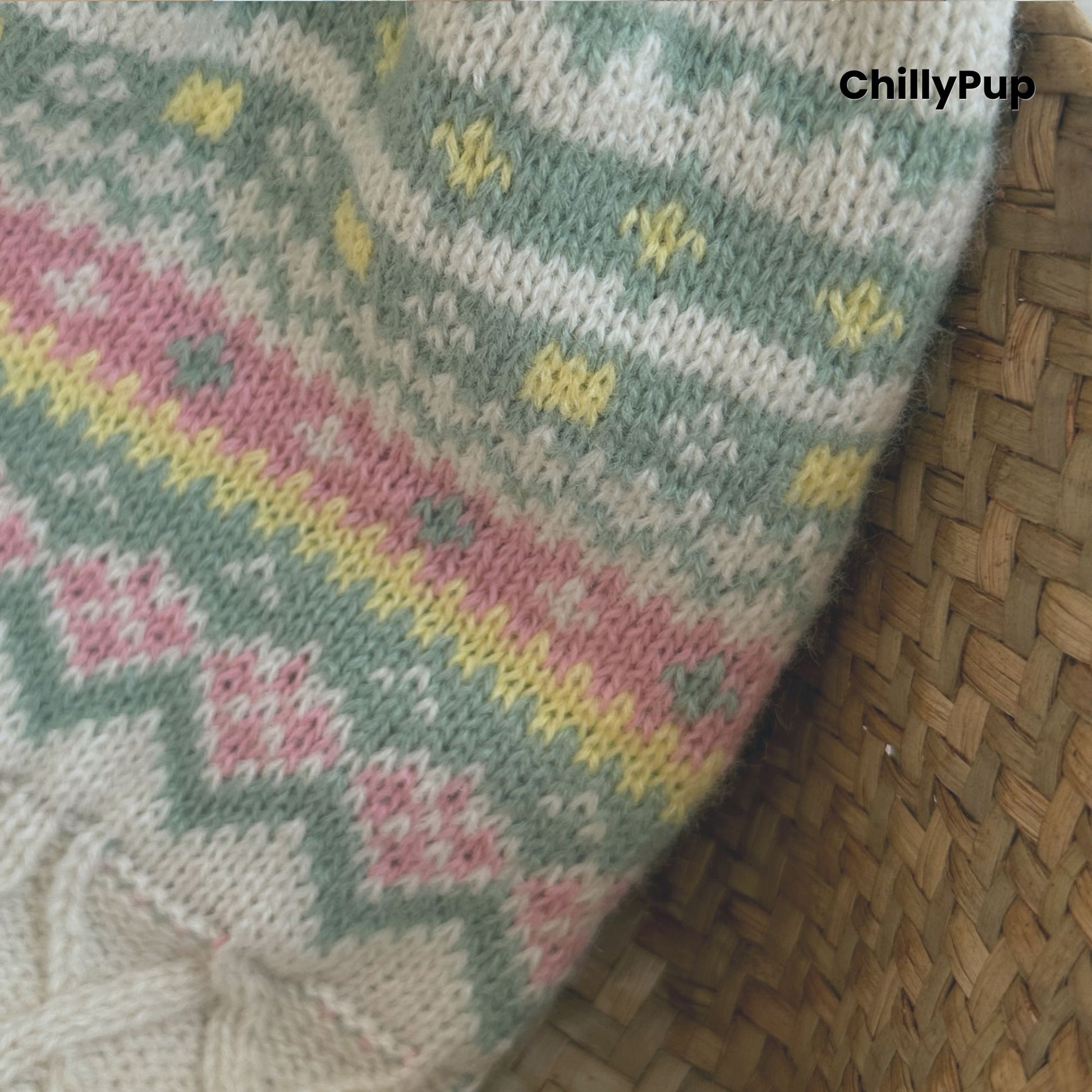 Knitted dog sweater with floral patterns on a wooden surface, branded 'ChillyPup'.
