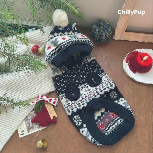 Knitted dog hoody with reindeer pattern on a wooden surface, branded 'ChillyPup'.