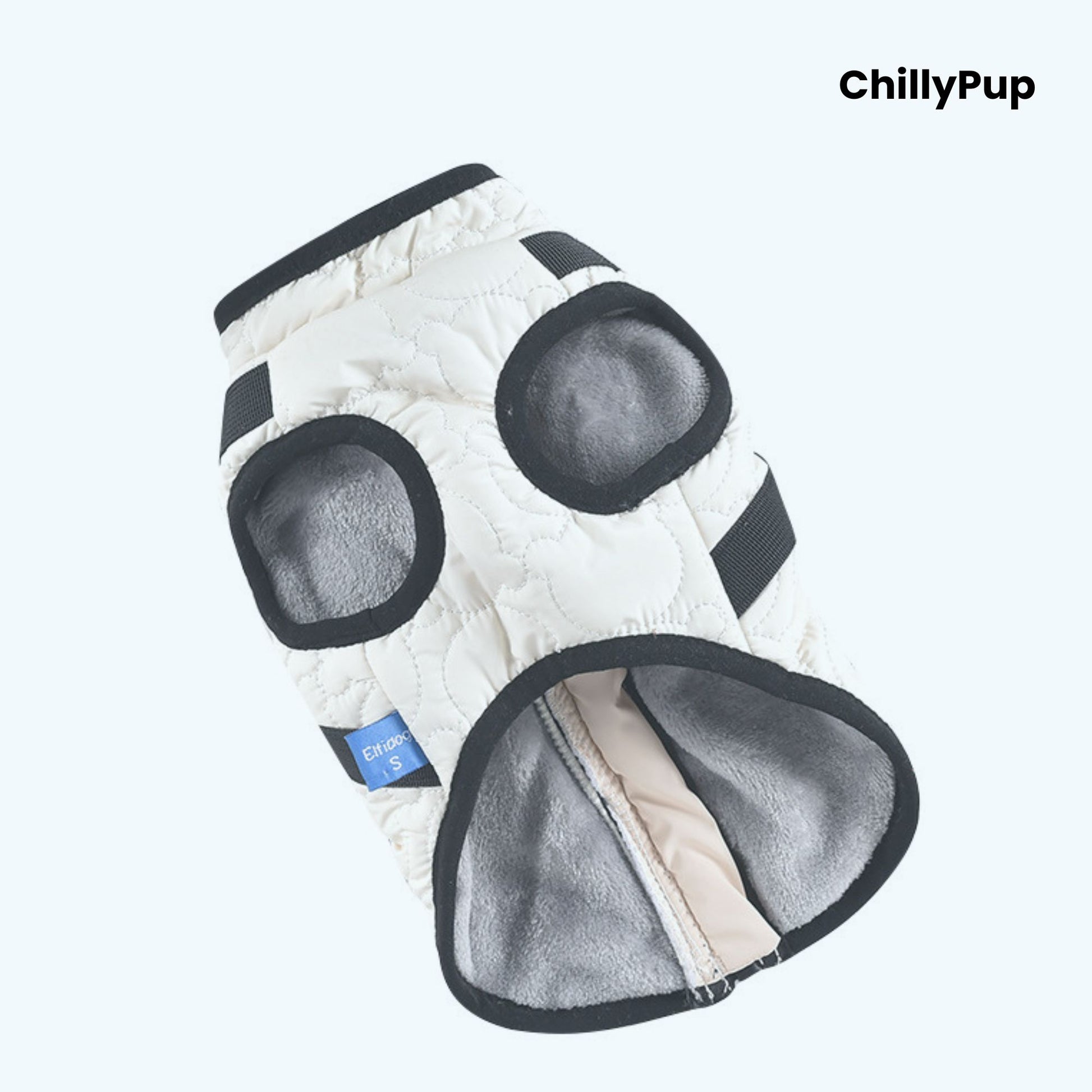 White dog coat with black straps on a white surface, branded 'ChillyPup'.