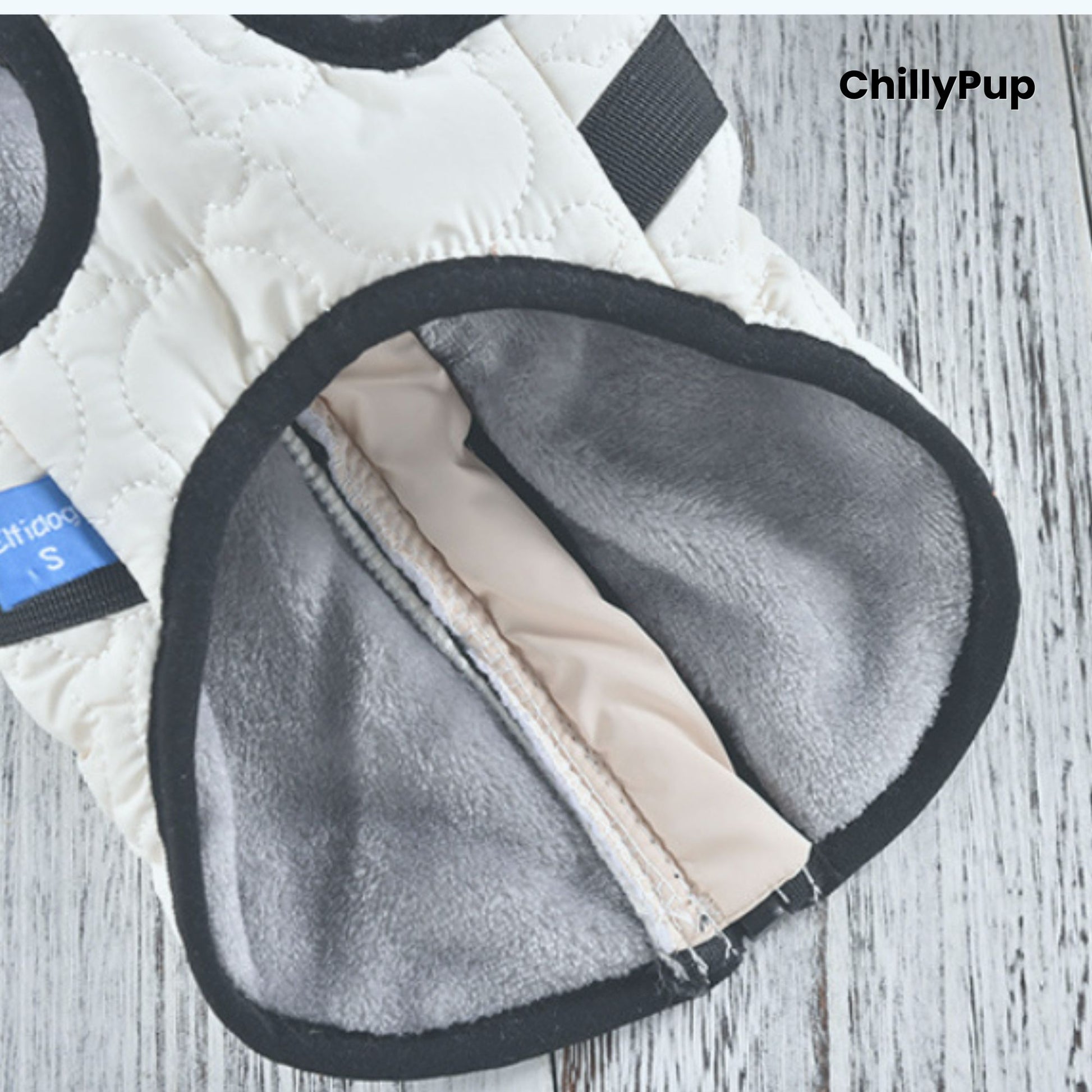 Close-up of a quilted jacket with a zipper and 'ChillyPup' branding.