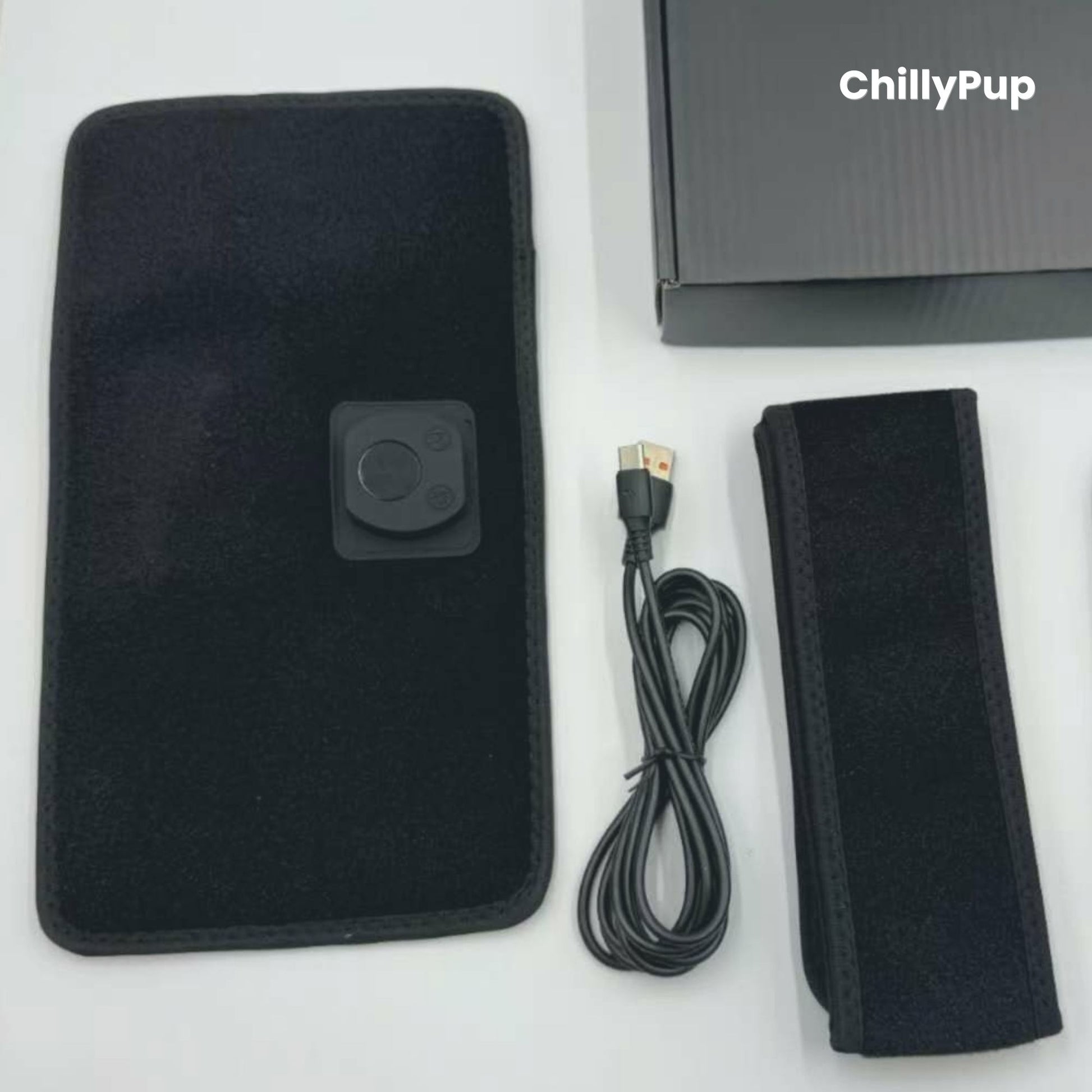 Black pet heating pad with USB cable and strap, branded 'ChillyPup', on a white background.