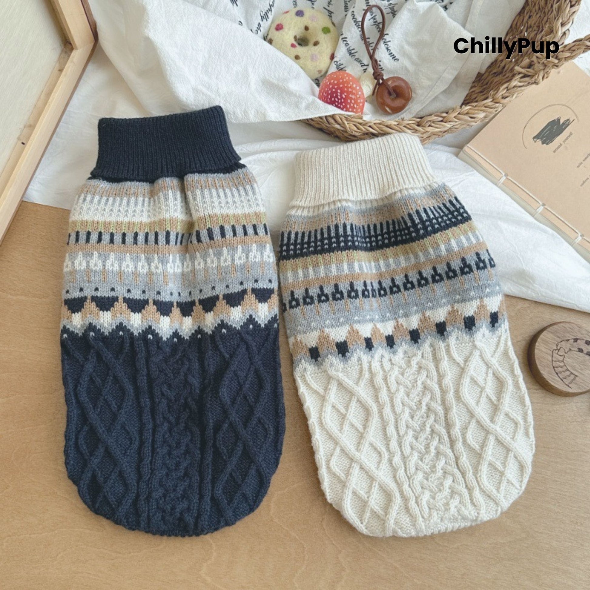 Pair of knitted dog sweaters with patterned design on a wooden surface, brand 'ChillyPup' visible.