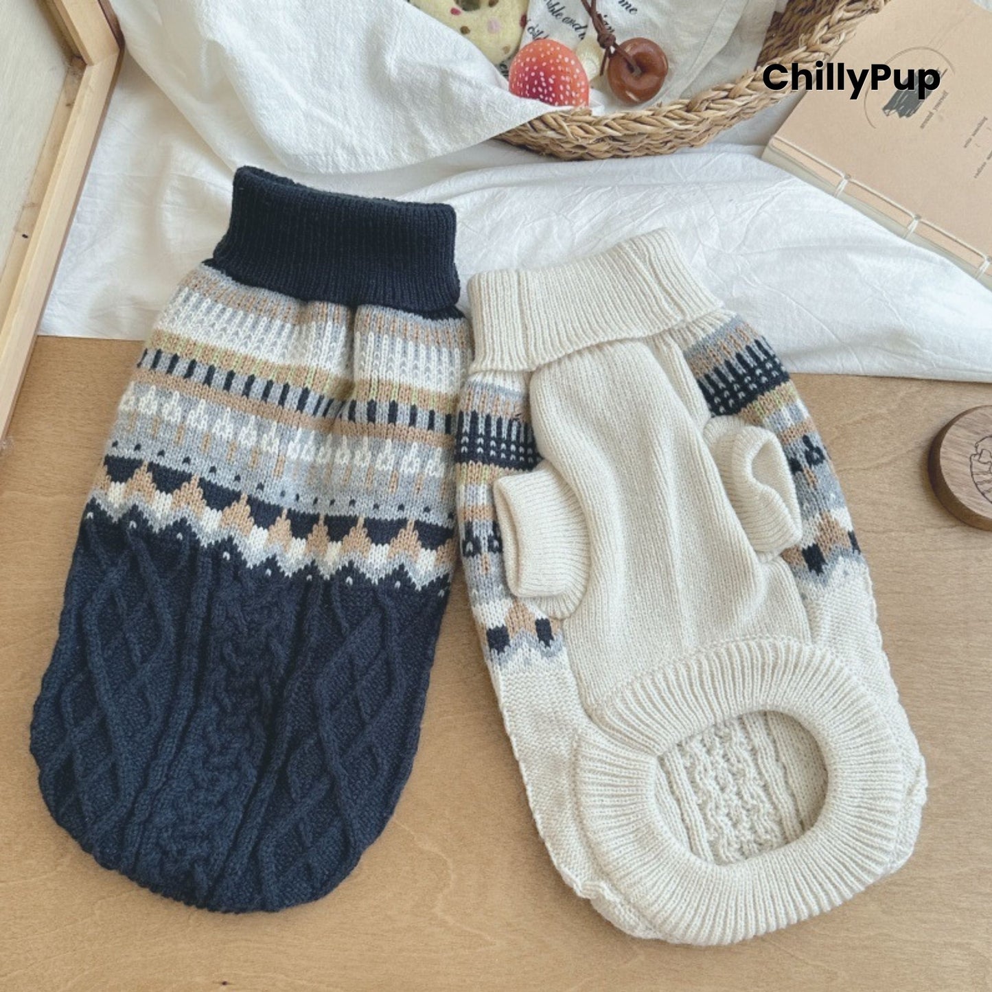 Pair of knitted dog sweaters with patterned design on a wooden surface, brand 'ChillyPup' visible.